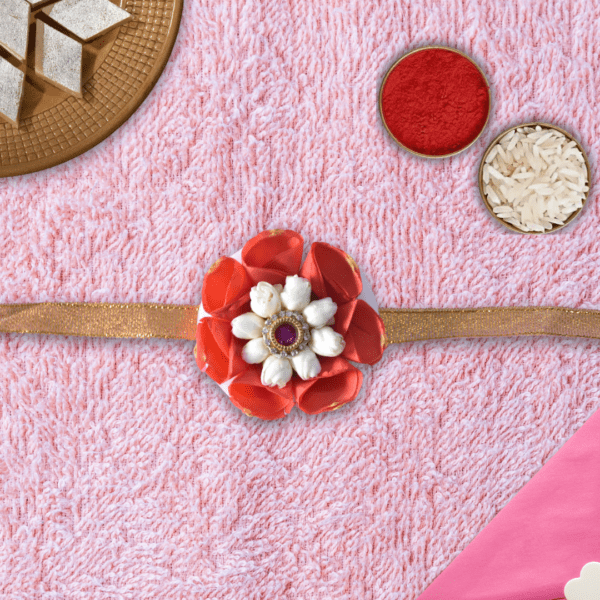 Floral rakhi with orange rose petals and arabian jasmine centerpiece