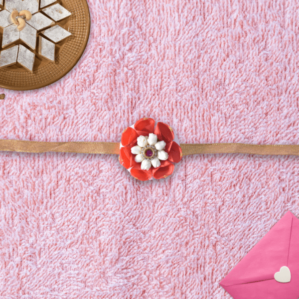 Floral rakhi with orange rose petals and arabian jasmine centerpiece