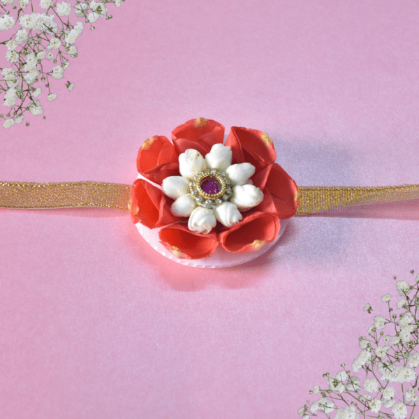 Floral rakhi with orange rose petals and arabian jasmine centerpiece