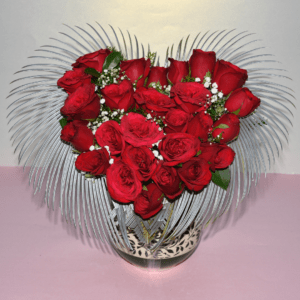 Heart-shaped vase filled with red roses and baby's breath, created by Hyderabad florist