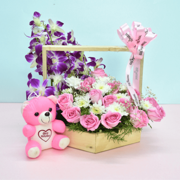 Flower basket with pink roses, white blooms, purple orchids, and a pink teddy bear for gifting in Hyderabad.