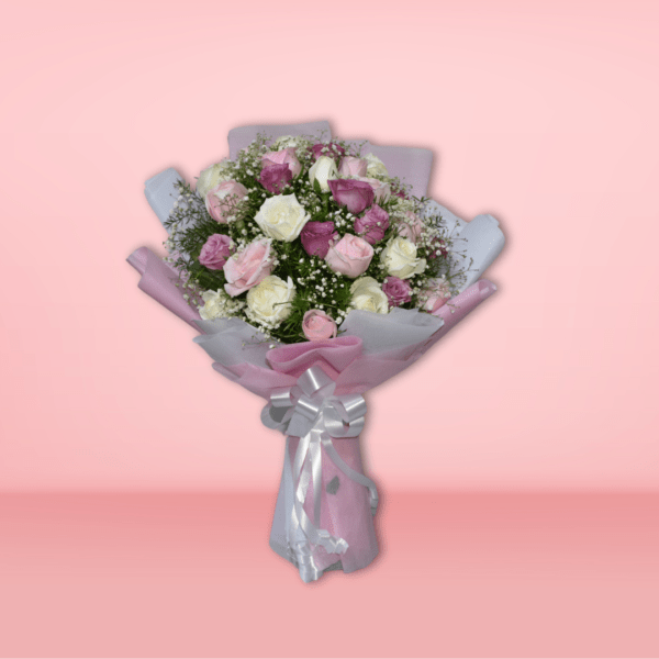 Elegant bouquet of pink, purple, and white roses wrapped in soft pink paper with a silver ribbon, perfect for special occasions.