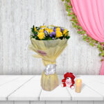 Gulmahal bouquet with yellow roses and purple flowers in cream wrapping