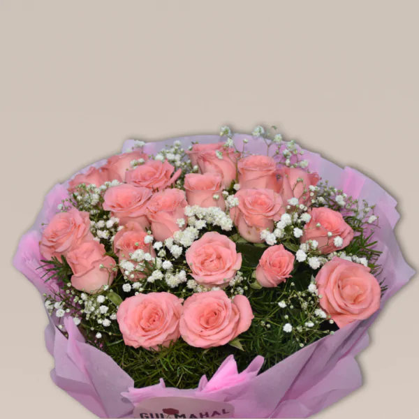 A bouquet of soft pink roses surrounded by baby's breath and greenery, wrapped in a pink paper with a delicate bow.