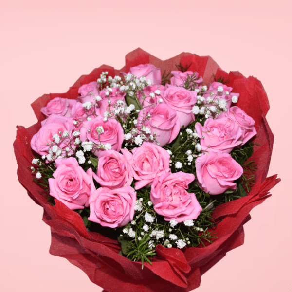 A bouquet of fresh pink roses surrounded by baby's breath and wrapped in red paper, perfect for special occasions.