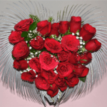 Heart-shaped vase filled with red roses and baby's breath, created by Hyderabad florist