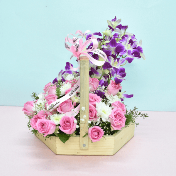 Flower basket with pink roses, white blooms, purple orchids, and a pink teddy bear for gifting in Hyderabad.