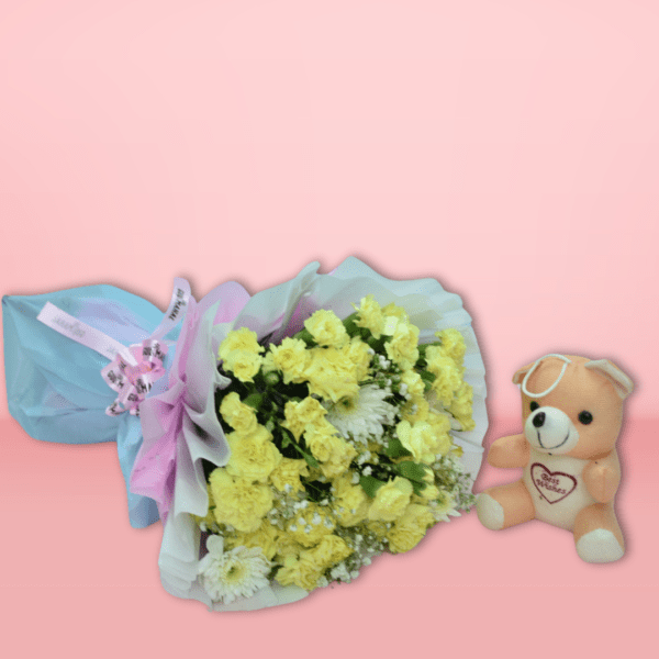 Vibrant yellow flower bouquet with carnations and baby's breath, wrapped in white and pastel paper, on pink background