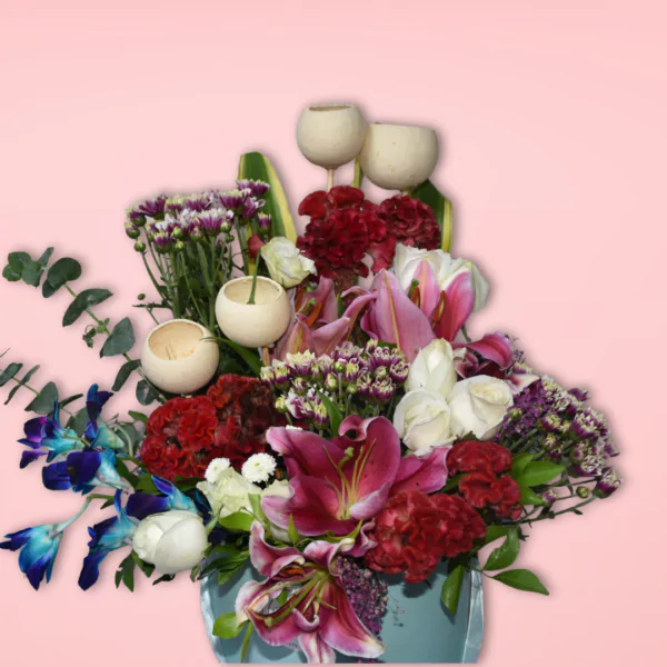 A beautiful floral bouquet featuring a variety of vibrant blooms, including red carnations, pink lilies, purple statice, and white tulips, presented in a charming turquoise vase