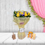 Gulmahal bouquet with yellow roses and purple flowers in cream wrapping