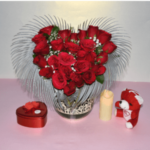 Heart-shaped vase filled with red roses and baby's breath, created by Hyderabad florist