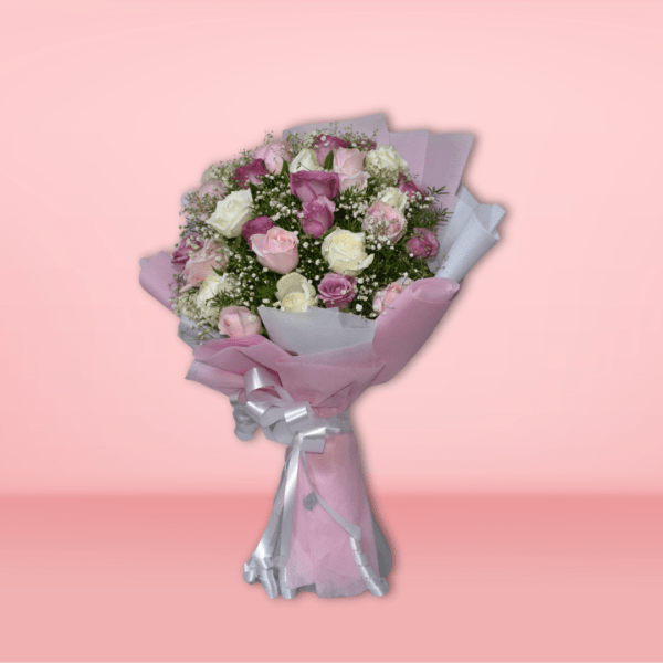 Elegant bouquet of pink, purple, and white roses wrapped in soft pink paper with a silver ribbon, perfect for special occasions.