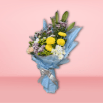 Mixed flower bouquet with yellow chrysanthemums, peach roses, white and purple carnations, wrapped in blue paper on a pink background.