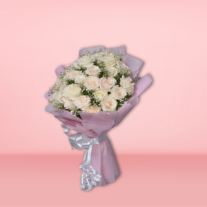 Elegant bouquet of white and blush roses with baby's breath, wrapped in pink paper with silver ribbon, on pink background