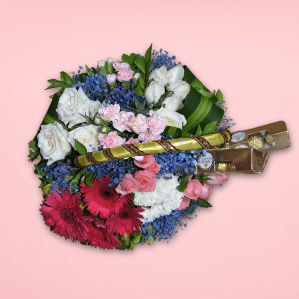 Flower basket with red gerberas, pink roses, white carnations, and Ferrero Rocher chocolates on a pink background.