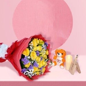 Colorful flower bouquet with yellow roses and purple flowers in red wrapping, Gulmahal brand, on pink background