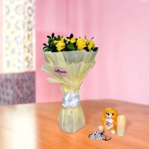 Vibrant bouquet of 20 yellow roses with greenery in black and white vase