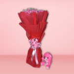 A bouquet of fresh pink roses surrounded by baby's breath and wrapped in red paper, perfect for special occasions.