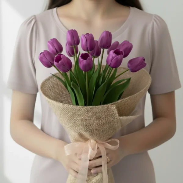 Purple Tulip flowers wrapped and held in hands by a girl