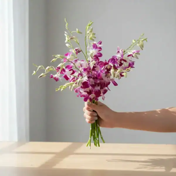 Purple Orchids held in Hand