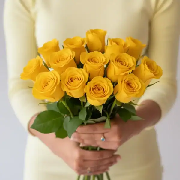 Yellow Roses held in a hand