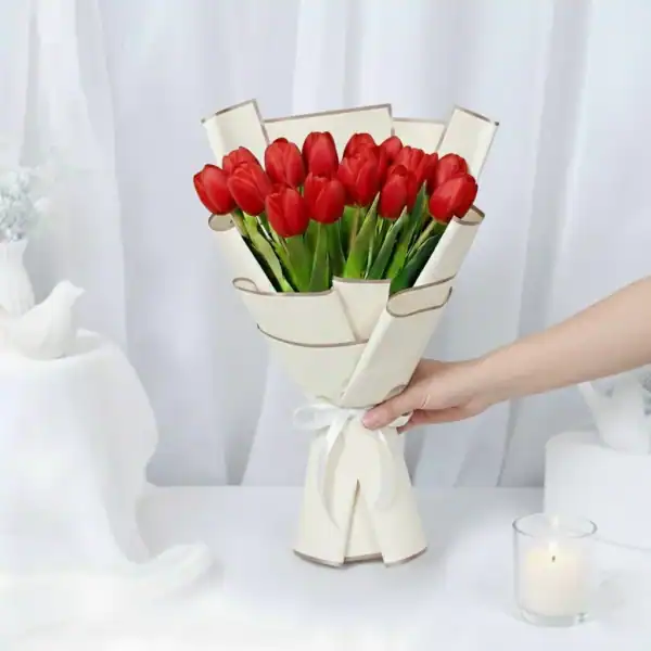 Red tulip flowers bouquet wrapped in beautiful korean paper