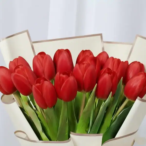 Red tulips bouquet wrapped in beautiful korean paper
