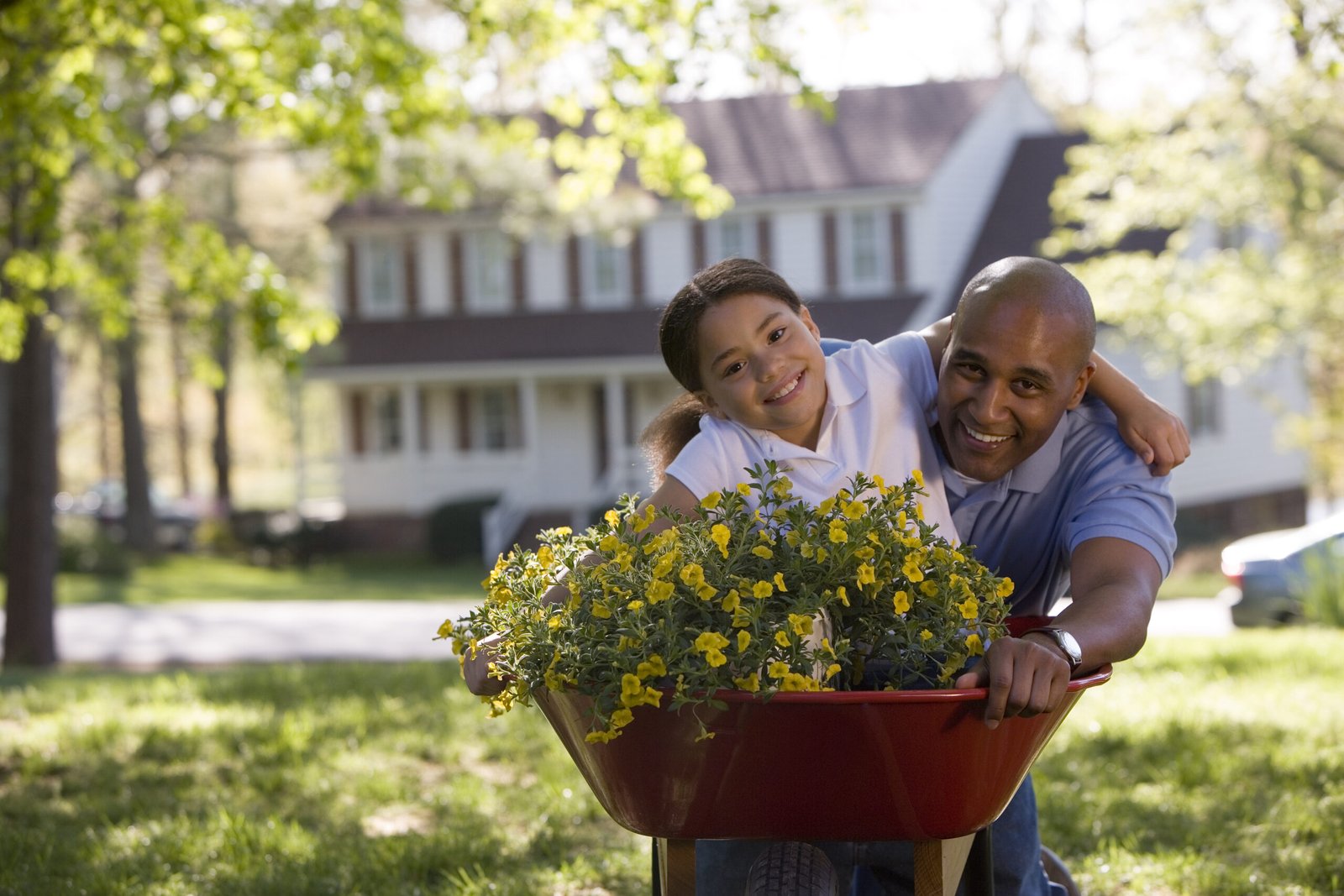 happy father and daughter with yellow flowers for father's day