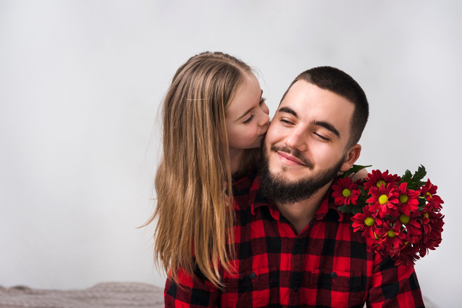 happy father and daughter together with red flower for father's day