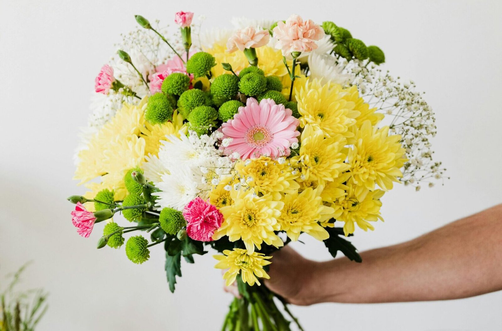 Florist arranging multi colour flower bouquet