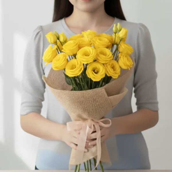 Yellow Eustoma wrapped and held in hands by a girl
