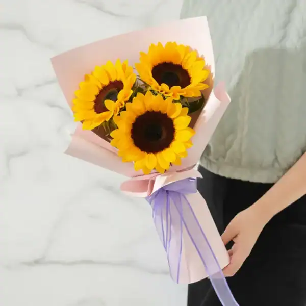 Sunflower bouquet held in hands