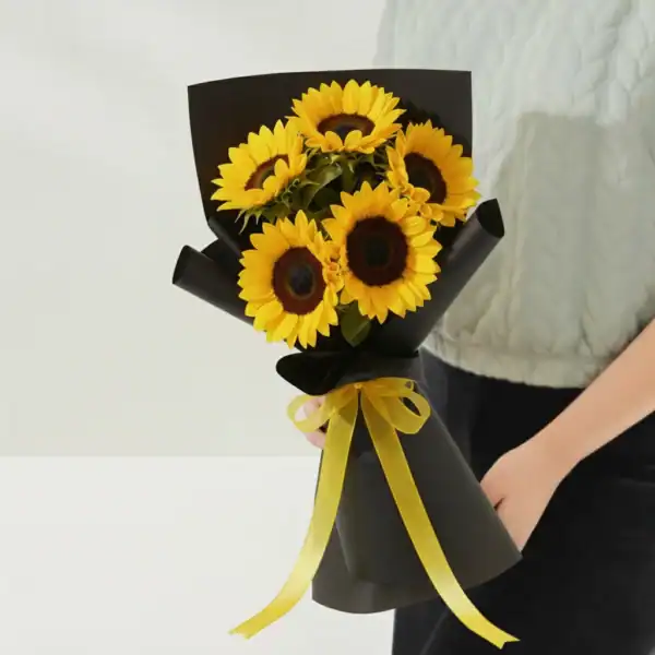 Sunflower bouquet held in hands