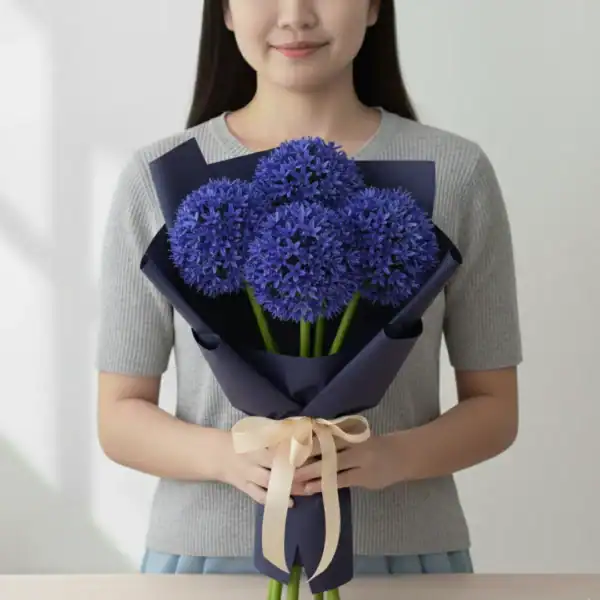 Blue Alliums wrapped and held in hands by a girl