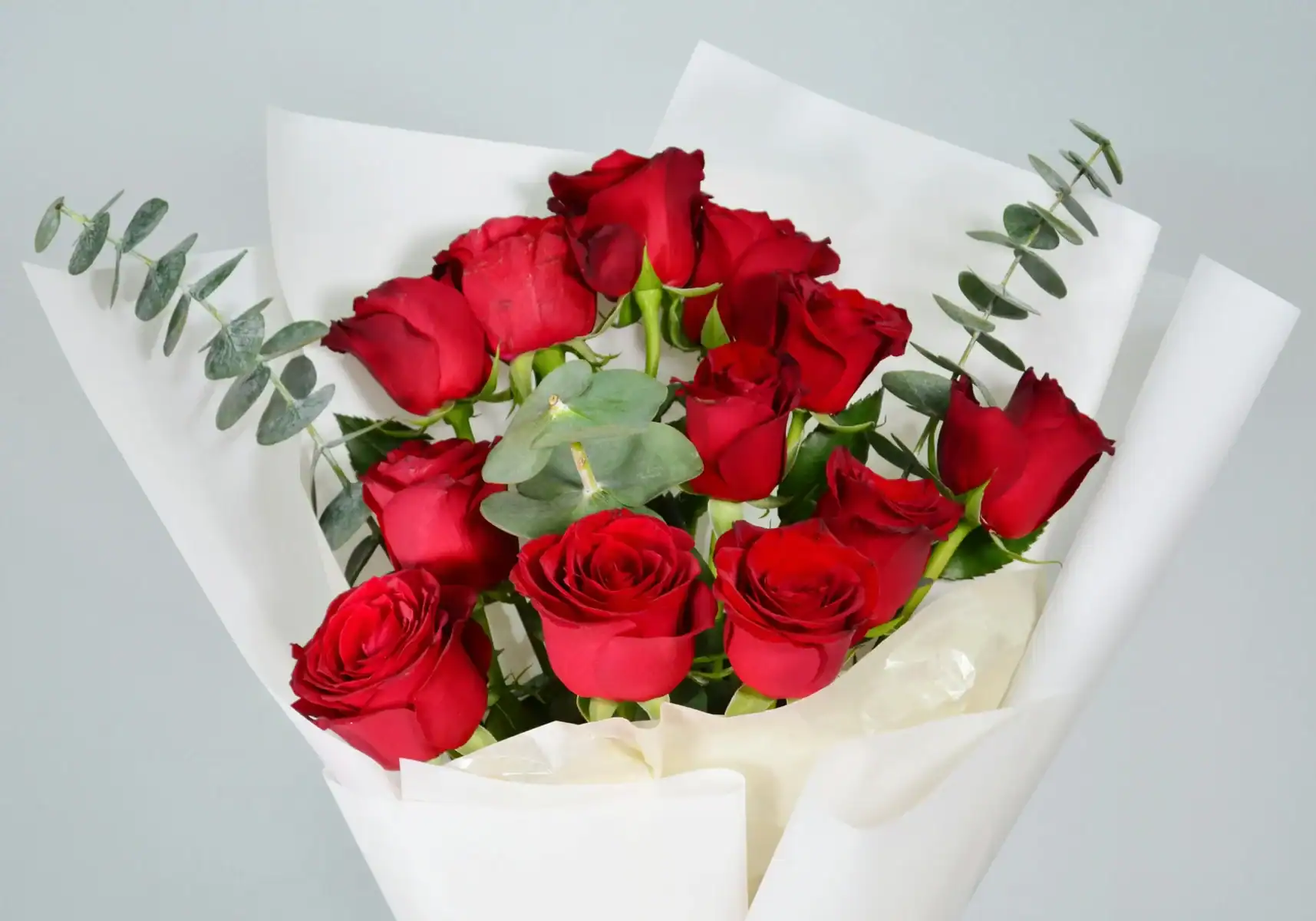 Classic red rose bouquet with eucalyptus wrapped in elegant white paper