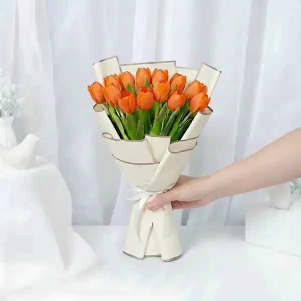 Orange tulip flowers bouquet wrapped in beautiful korean paper