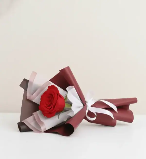 Single Stem Red Rose Bouquet on table